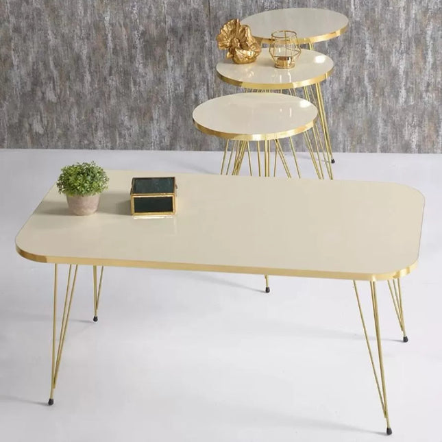 Beige coffee table with gold legs and smaller round tables in the background.