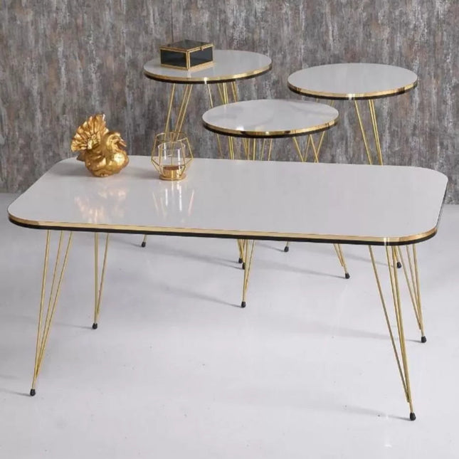 Set of marble coffee tables with gold legs against a gray background